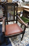 A set of six Carolean style carved oak dining chairs (two having arms)