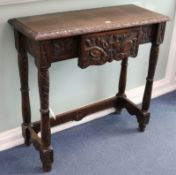 A carved oak side table fitted drawer W.91cm.