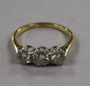 A three-stone diamond ring, the brilliants approx 1.45ct, platinum set on 18ct yellow gold shank