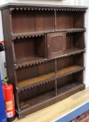 An oak open bookcase fitted cupboard W.128cm.