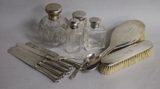 A collection of silver mounted dressing table items including brushes and jars, five silver