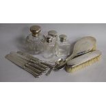 A collection of silver mounted dressing table items including brushes and jars, five silver