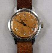 A gentleman's early 1940's stainless steel Omega manual wind wrist watch with copper coloured dial.