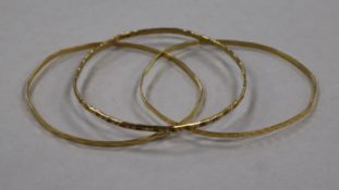 A 9ct gold bangle and two 18ct gold bangles, 15g