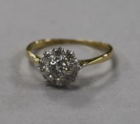 An early 20th century 18ct gold and platinum diamond cluster ring, size L.
