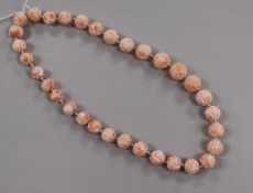 A single strand carved coral bead necklace, 50cm.