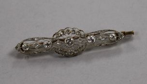 An early 20th century pierced yellow metal and diamond set bar brooch, 48mm.