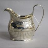 A George III silver helmet shaped cream jug, London, 1903, 11cm.