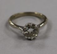 An 18ct gold and platinum solitaire diamond ring, the round cut stone weighing very approximately
