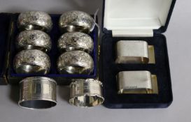 A cased set of six late Victorian silver napkin rings, Birmingham, 1897, a later pair and two