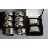 A cased set of six late Victorian silver napkin rings, Birmingham, 1897, a later pair and two