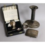 A silver egg cup and spoon, a cigarette case, a 19th century silver candlestick and a napkin ring.