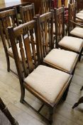 A set of five and a set of four similar oak slatted back dining chairs