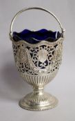 A Victorian pierced silver sugar vase with handle and blue glass liner, Robert Harper, London, 1876,