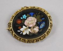 A late Victorian yellow metal and pietra dura oval brooch, decorated with flowers, 47mm.