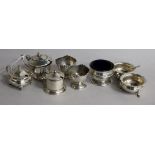 Six assorted silver condiments and two silver egg cups.