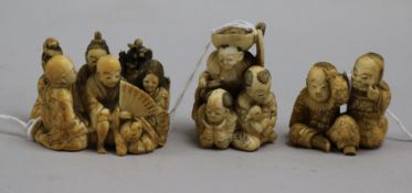 Three Japanese ivory groups of seated figures