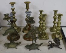 A collection of mixed brass candlesticks