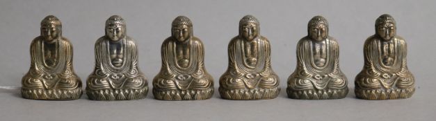 A set of six novelty sterling silver condiments, each modelled as a seated Buddha, one base missing,