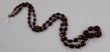A single strand graduated simulated cherry amber facetted bead necklace, 88cm.