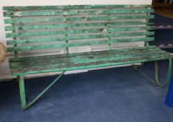 An Edwardian iron and slatted wooden garden bench W.183cm.