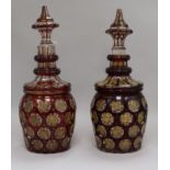 A pair of Bohemian gilt and ruby flash cut decanters with spear stoppers height 34cm