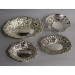 A late Victorian repousse silver bonbon dish, London, 1892 and three other bonbon dishes.