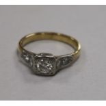 A yellow metal and single stone diamond ring with diamond set shoulders, size O.