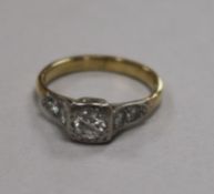 A yellow metal and single stone diamond ring with diamond set shoulders, size O.