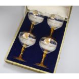 A set of four 1937 Coronation champagne coupes, in Mappin & Webb case, the glasses inscribed in gilt