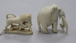 A 19th century Indian ivory carving of a bull elephant, height 7cm, and a carving of a lion