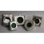 Five assorted travelling watch cases including white metal heart shape and four silver, including