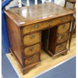 A walnut kneehole desk W.81cm