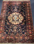 A large Persian black ground rug 170cm x 125cm