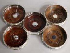 Two pairs of modern silver mounted wine coasters and a single silver mounted wine coaster.