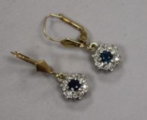 A pair of 9ct gold, sapphire and diamond cluster earrings.