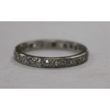 A white metal and diamond set full eternity ring, size N.