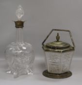 A silver mounted glass decanter and stopper and a biscuit barrel. height 31cm