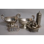 A small group of silver items including pair of sauceboats, toastrack, condiments, sugar sifter