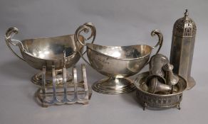 A small group of silver items including pair of sauceboats, toastrack, condiments, sugar sifter