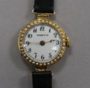 A lady's 18ct gold and split pearl set manual wind wrist watch, retailed by Tiffany & Co.