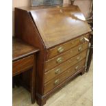 A mahogany bureau fitted four graduated long drawers W.101cm