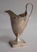 A George III silver helmet shaped cream jug, Peter & Ann Bateman? London, 1791, base filled? 15.
