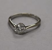 An 18ct white gold, platinum and solitaire diamond ring, size L.