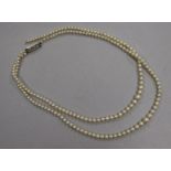 A double strand graduated cultured pearl necklace with cultured pearl set clasp (a.f.), 42cm.