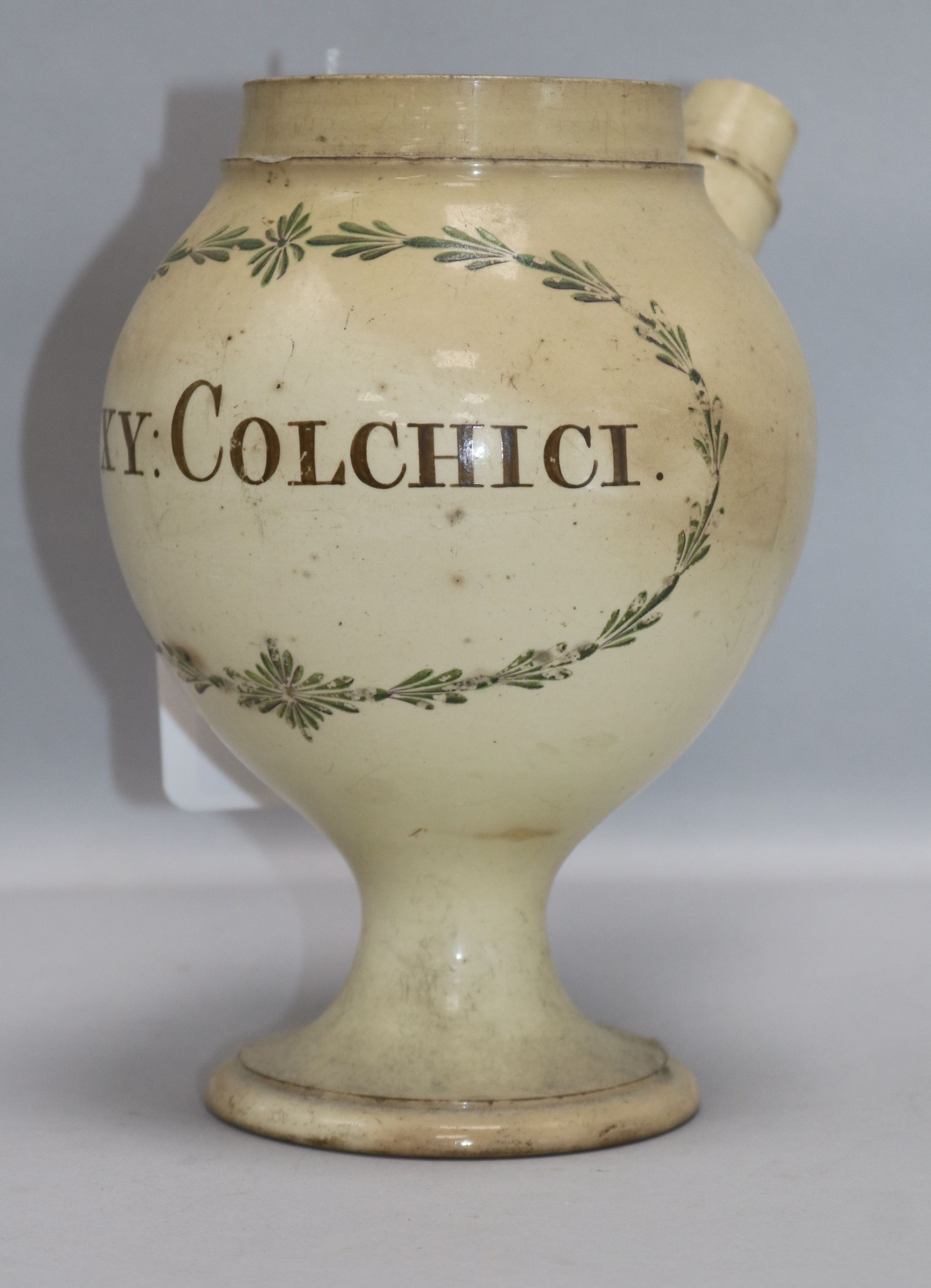 An 18th century English creamware wet drug jar, of globular form on pedestal foot with cylindrical