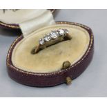 An early 20th century yellow metal and graduated five stone diamond ring size M.