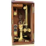 A late 19th century lacquered brass binocular microscope by Cary, 181 Strand, London, in fitted