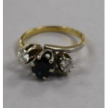 An 18ct gold and three stone sapphire and diamond ring, size N.