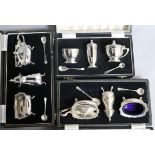 Three assorted cased three piece silver condiment sets.